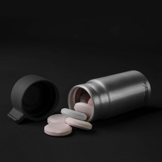 Canister full of antacids on black background