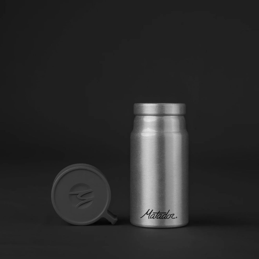 Front of canister with lid off on black background