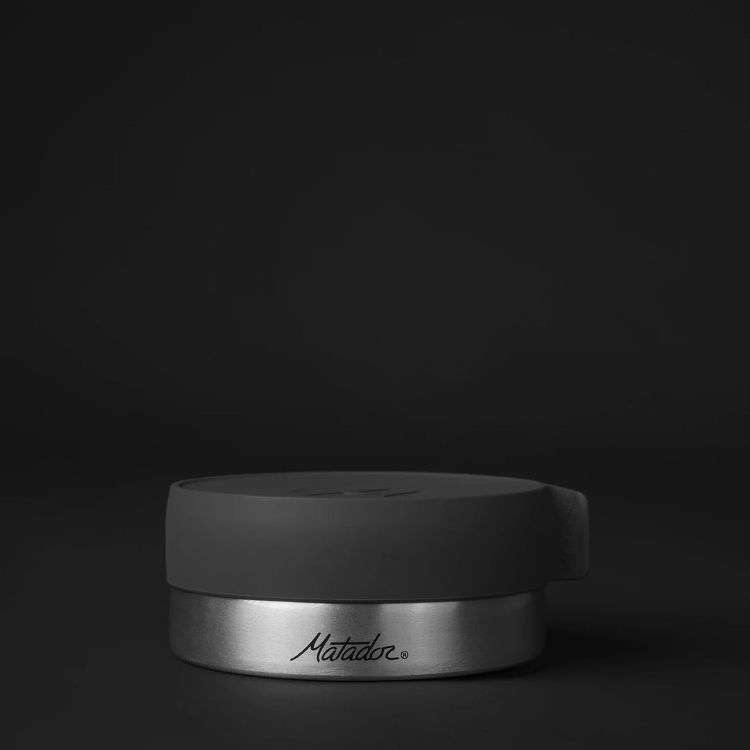 Front of large canister on black background