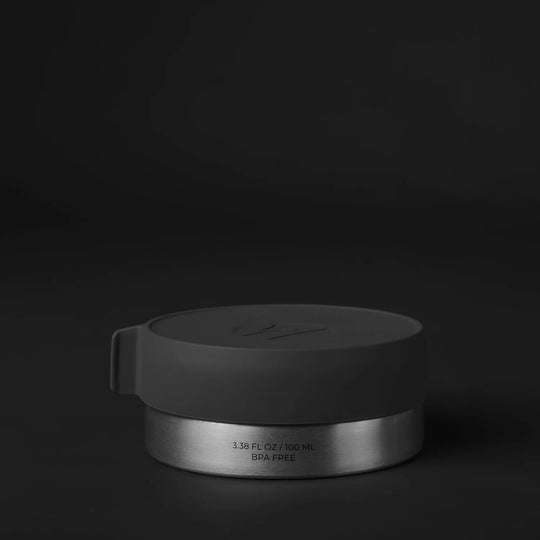 Front of large canister on black background