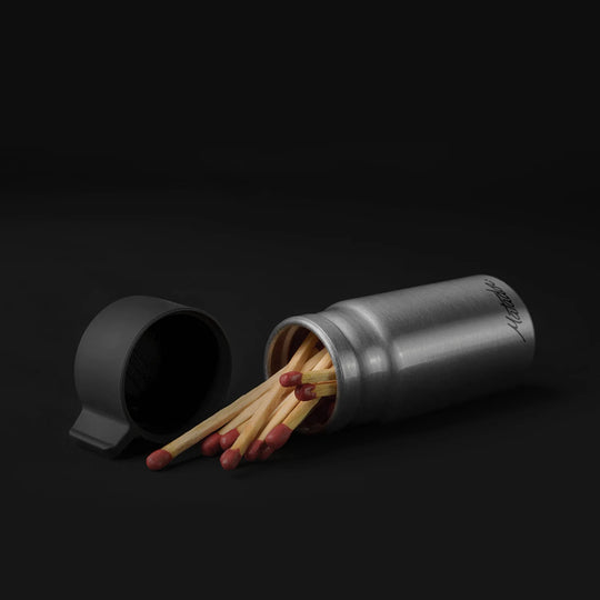 Canister full of matches on black background