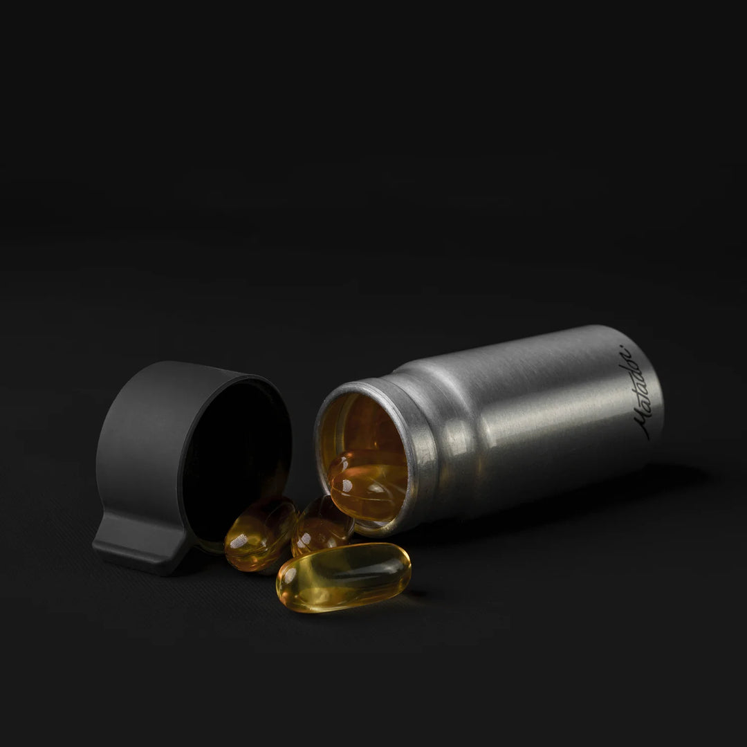 Canister full of fish oil pills on black background