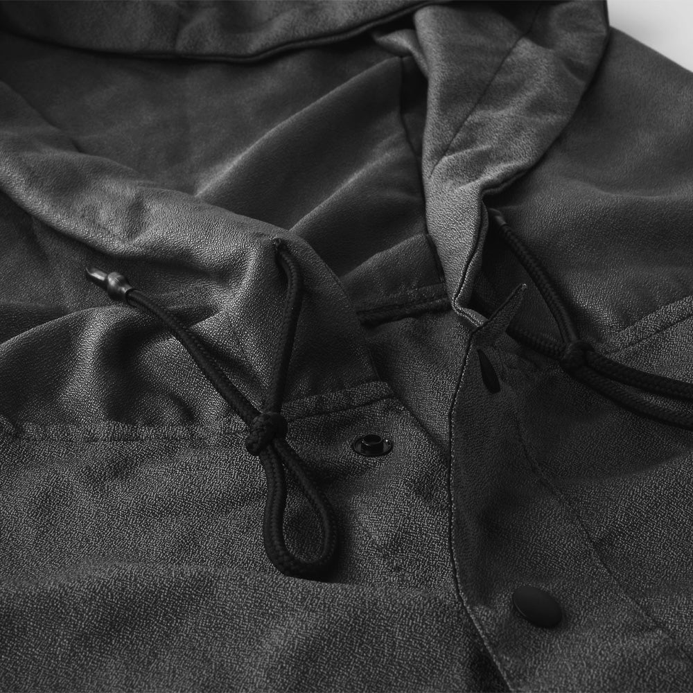 Close up view of charcoal poncho details including hood pull stings and snap button collar