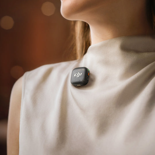 Person wearing a DJI Mic Mini on their chest with a blurred background