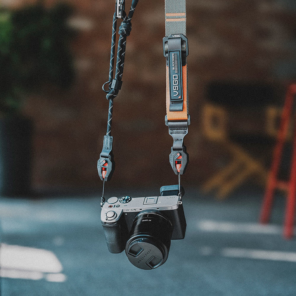 Camera hanging from a strap with a blurred background