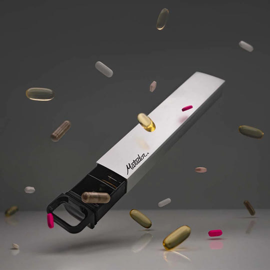 Partially open pill canister floating on gray background, surrounded by floating pills