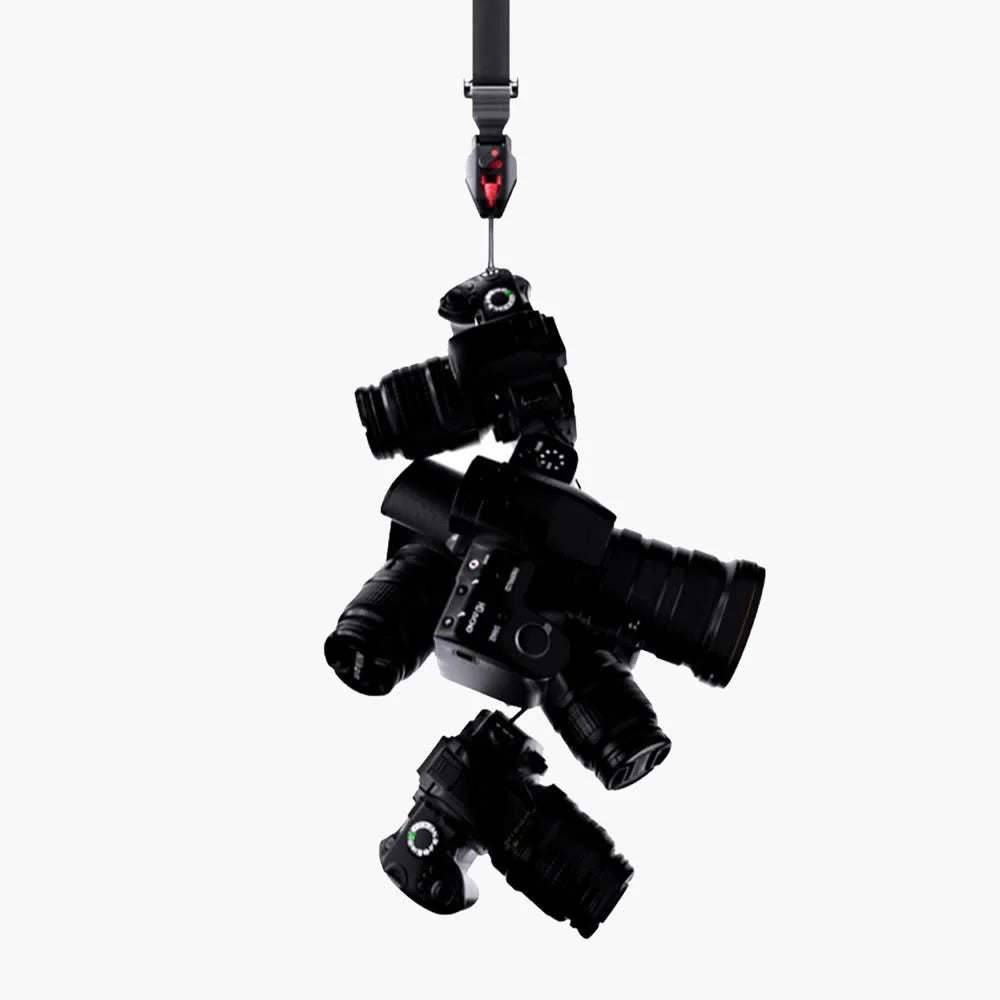 Black multiple camera attached to a strap on a white background