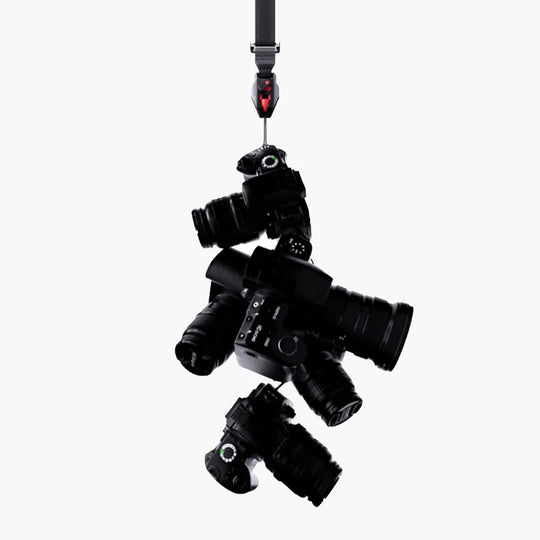Black multiple cameras attached to a VSGO wrist strap on a white background