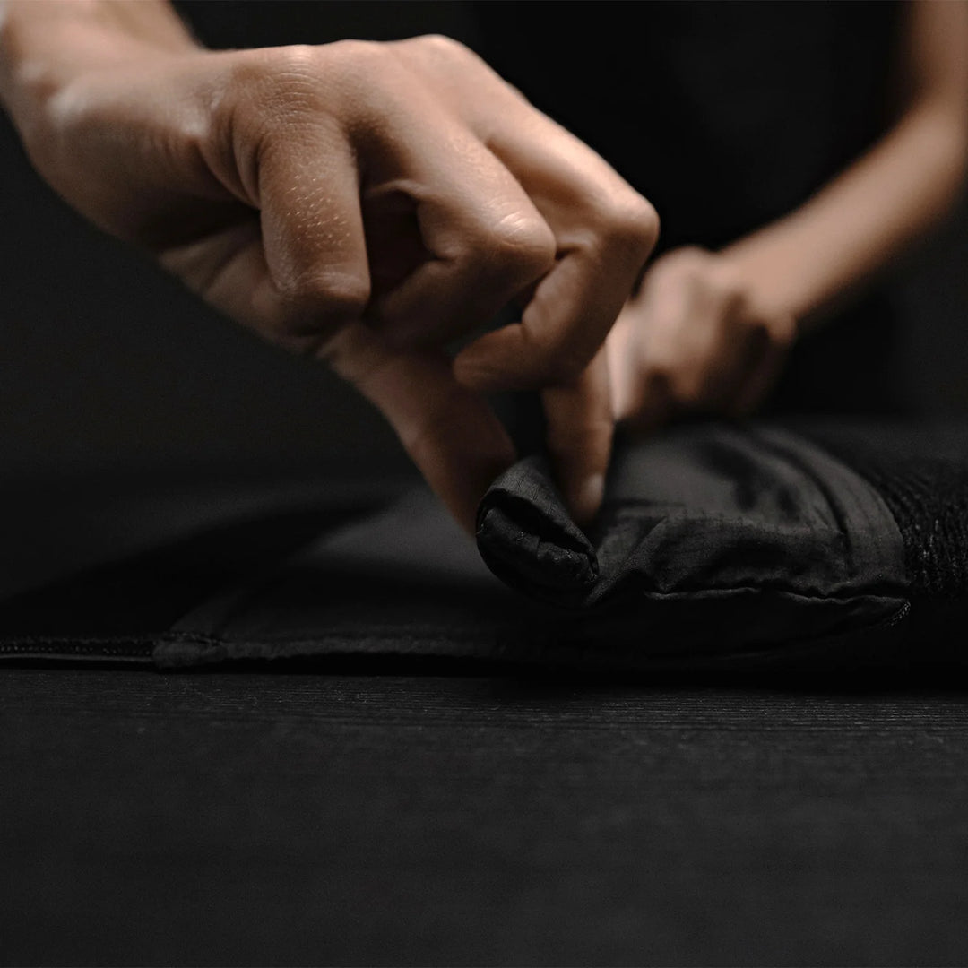 Hands rolling up top closure