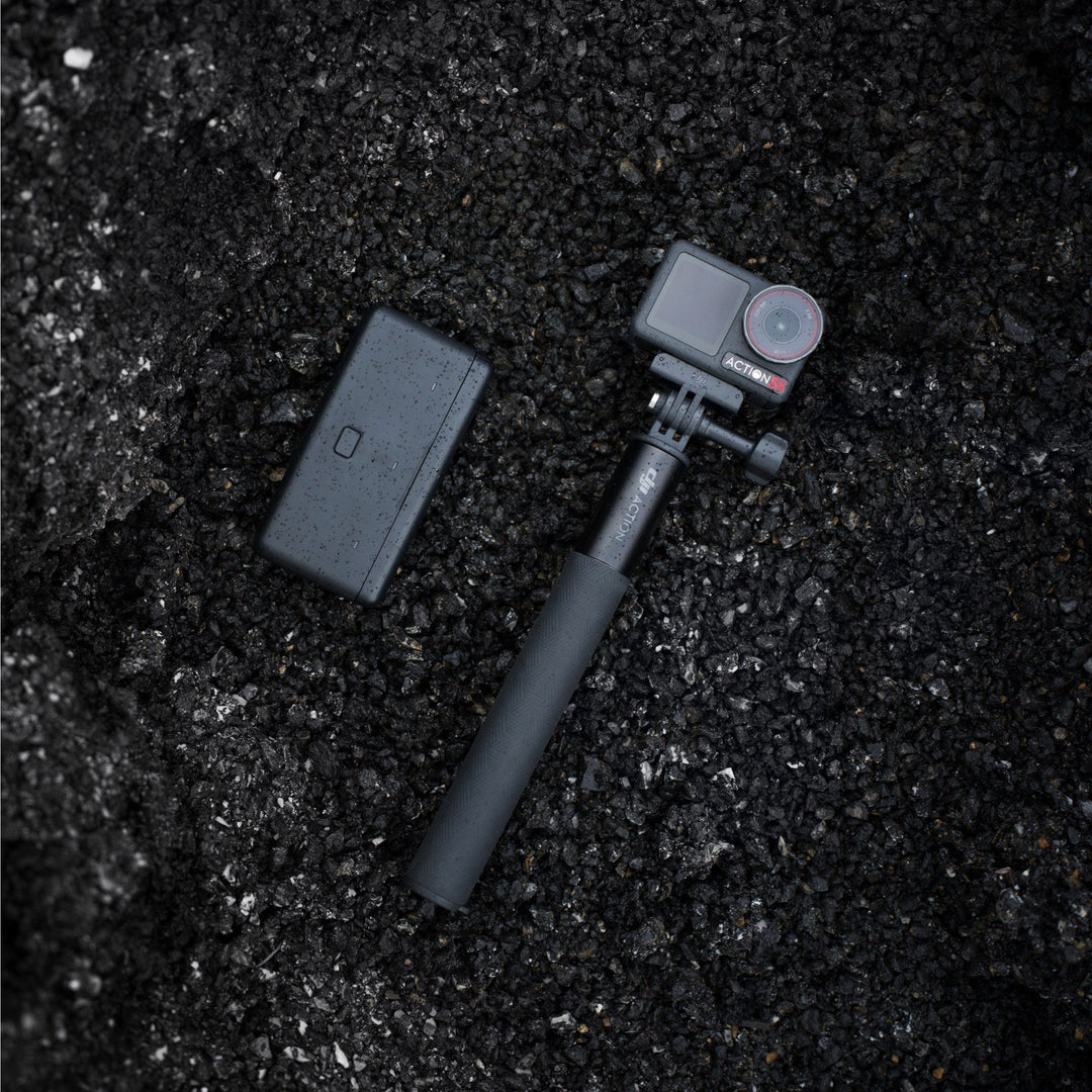 Action camera with remote control on a dark textured surface