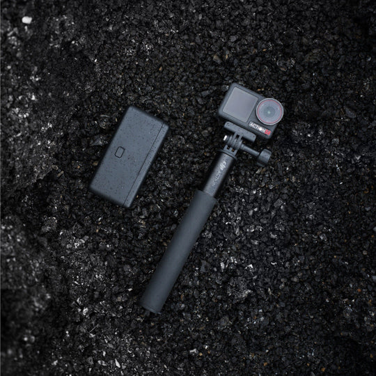 Action camera with remote control on a dark textured surface