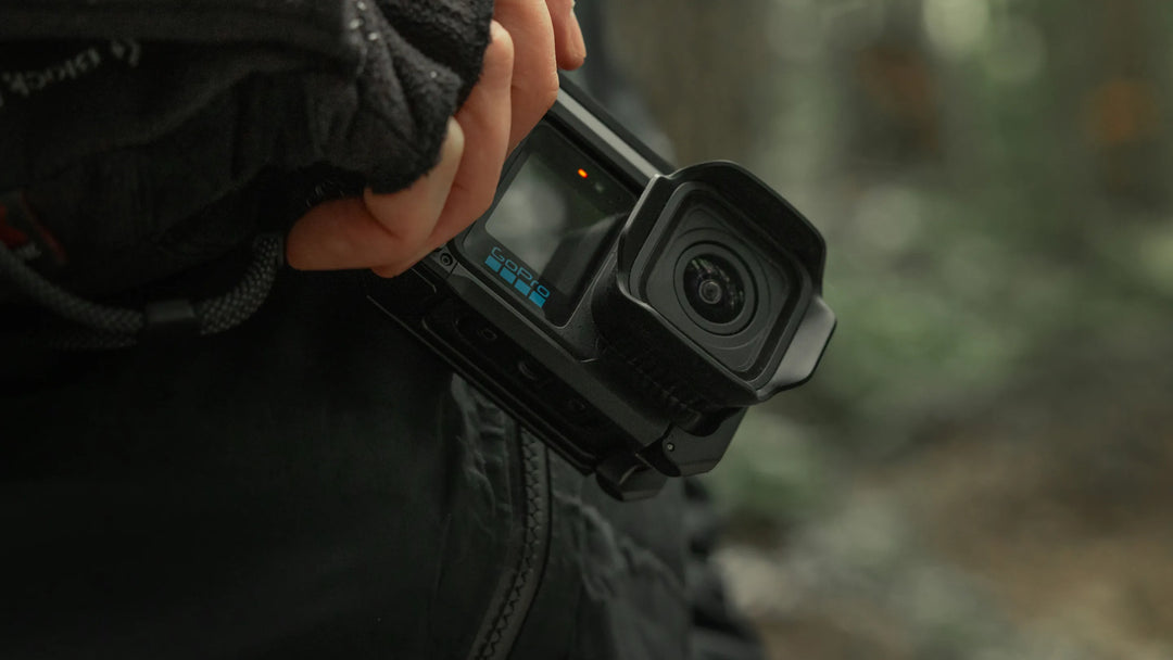 Person holding a Gopro Mission 1 black action camera with a blurred background