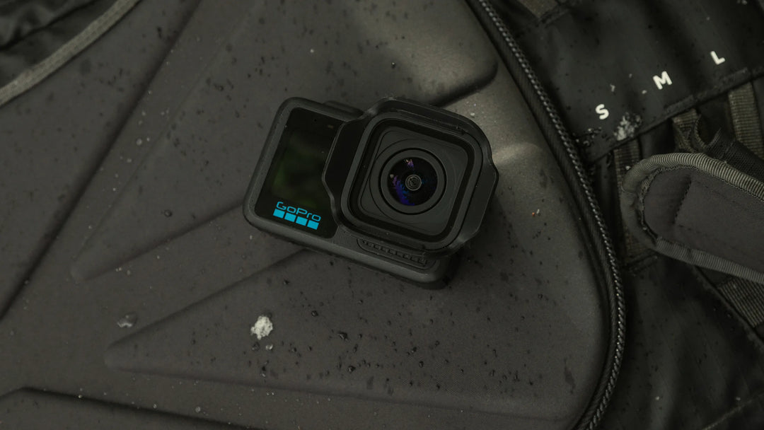Action camera on a textured surface with visible brand name