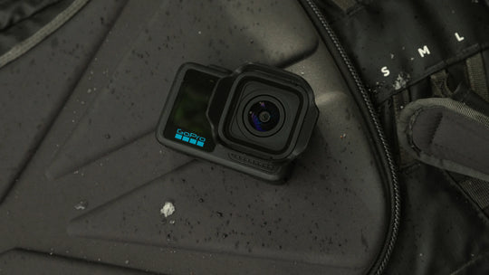 Action camera on a textured surface with visible brand name