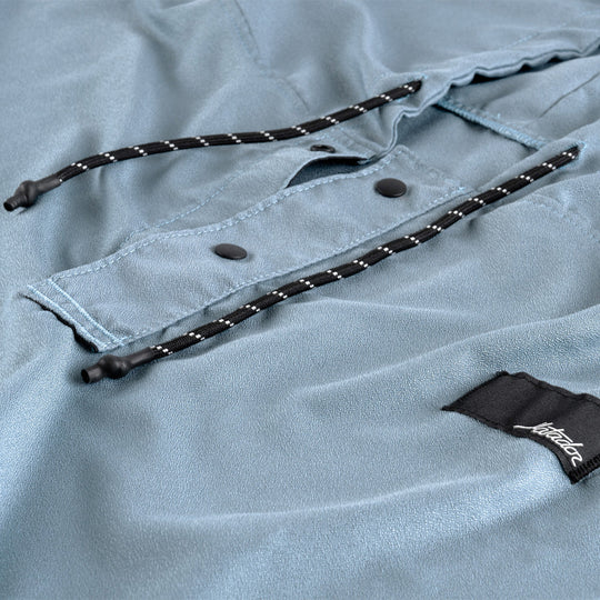 Light blue shirt with black drawstrings and a brand label on a light gray background