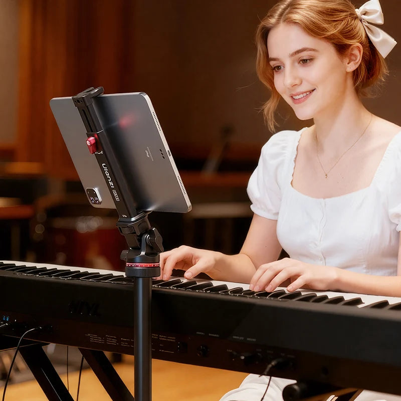 Woman playing a keyboard with a tablet on a stand in front of her