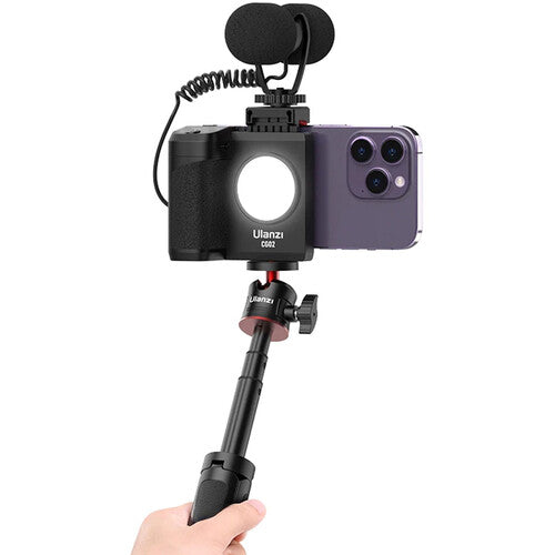 Hand holding a smartphone with Ulanzi CG-02 Smartphone Camera Grip Holder attachment and microphone on a white background