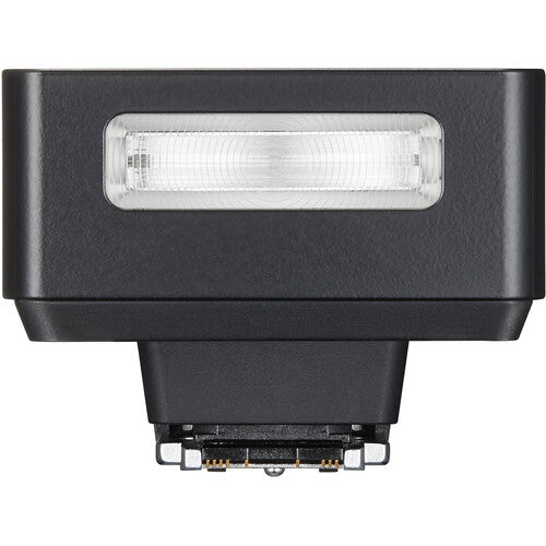 Black camera flash with a clear lens on a white background