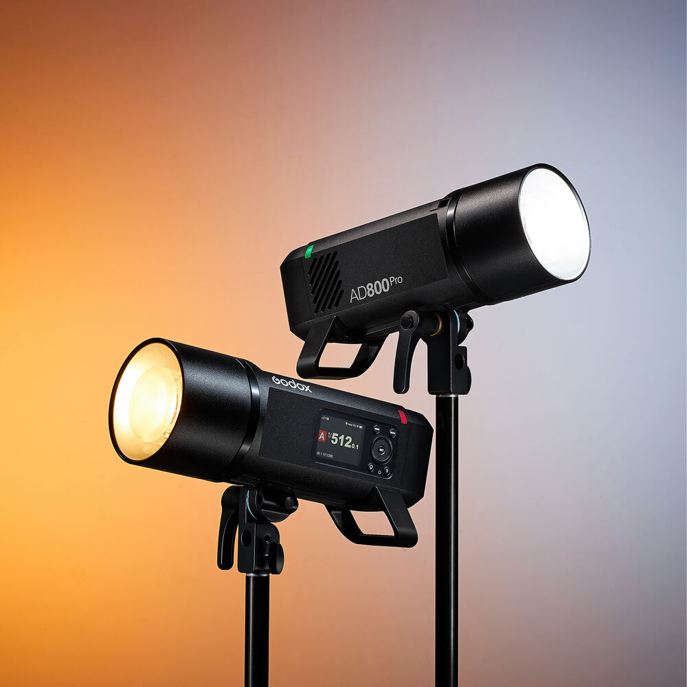 Two studio lights on stands with a gradient background