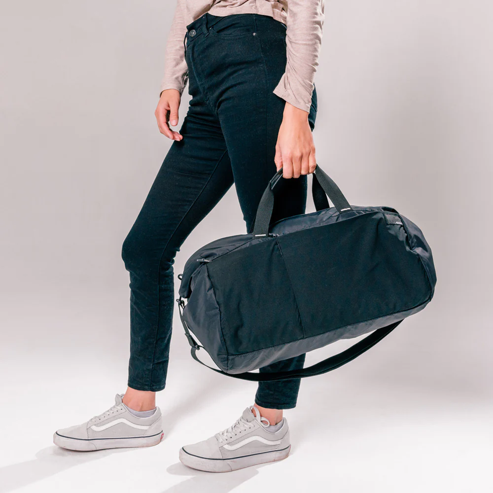 A model holding Matador ReFraction Packable Duffle bag