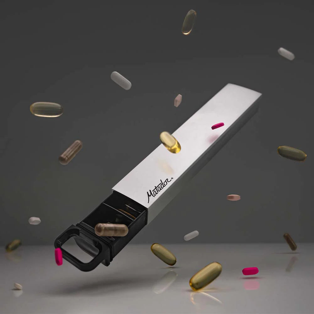 A waterproof pill canister with a crush-proof aluminum shell, featuring a sliding insert with 7 numbered slots for organization, and the Matador brand logo.