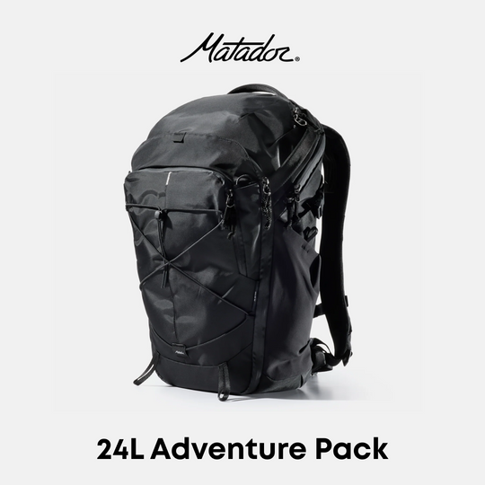 A black Matador 24L Adventure Pack backpack shown from a three-quarter angle on a light gray background, with the Matador logo at the top and &