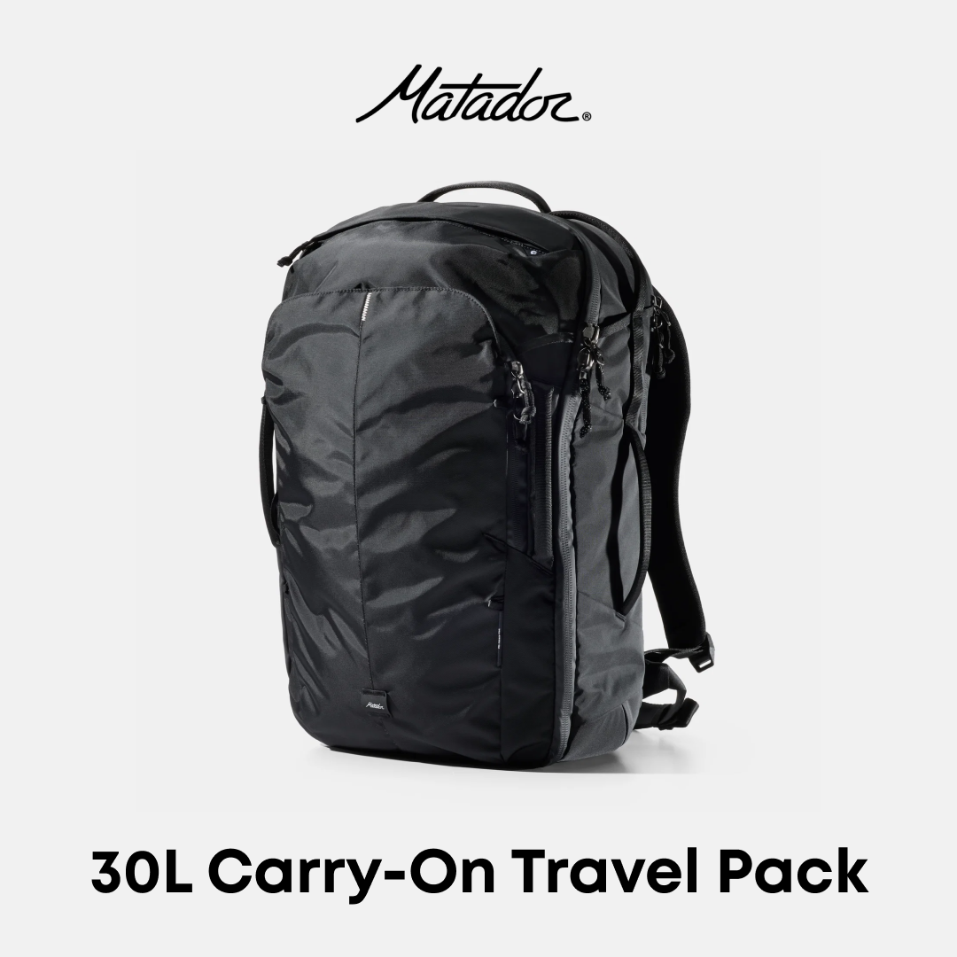 A black Matador 30L carry-on travel backpack shown on a light gray background with the Matador logo at the top and &