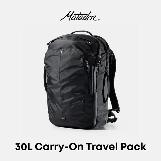 A black Matador 30L carry-on travel backpack shown on a light gray background with the Matador logo at the top and &