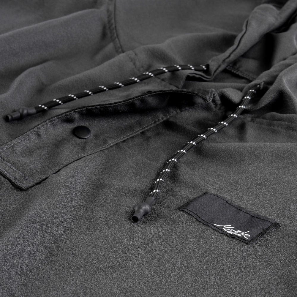 Close-up of a NanoDry Packable Towel Poncho with a brand label on a matching background