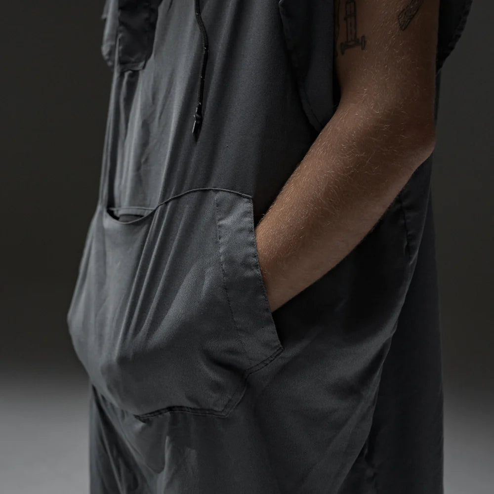 Person wearing a NanoDry Packable Towel Poncho with a pocket on a gradient background