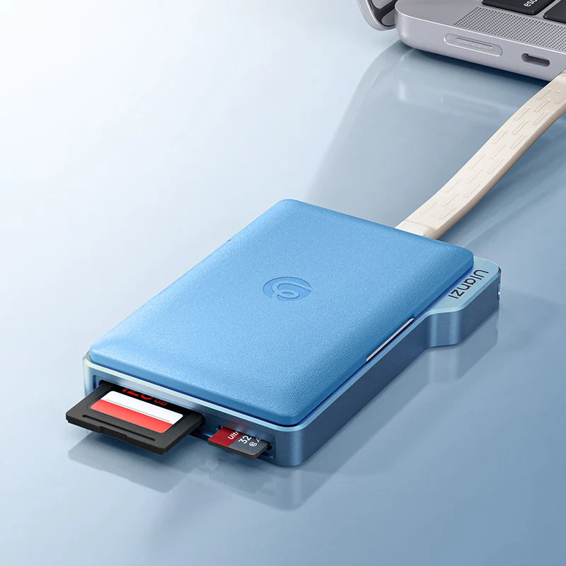 A light blue portable SSD with a built-in wooden handle, shown with an SD card partially ejected from the front slot. The SSD features a textured blue top cover with a subtle circular logo in the center and 'Ulanzi' printed on the side.