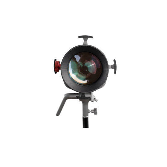 A studio light modifier or reflector head with a large circular glass lens, black metal body, side adjustment knobs, and a support stand, isolated on a white background.