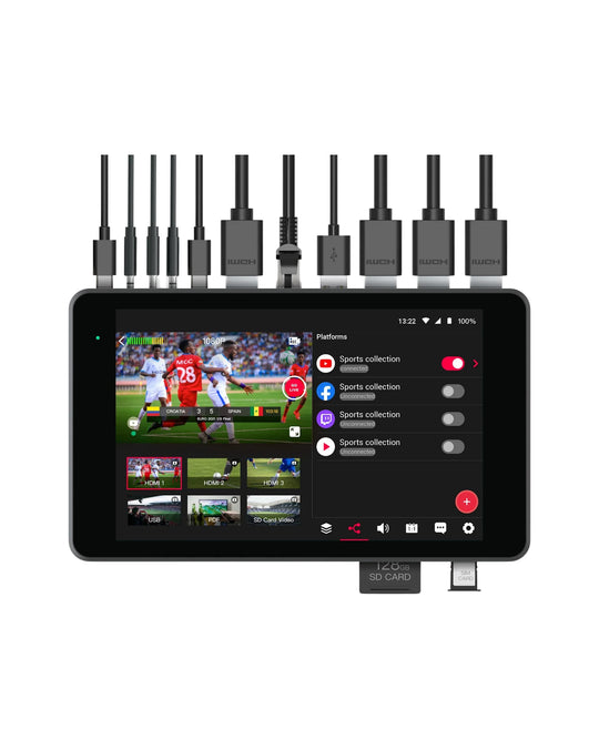 A black YoloLiv YoloBox Pro streaming device with multiple black cables plugged into the top port array, shown on a plain white background. The front screen displays a video player interface with sports content and device status icons.
