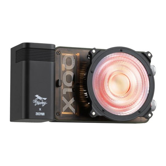 A black ZHIYUN MOLUS X100 RGB with a transparent side panel showing a gold CPU inside, featuring a large circular fan with a glowing red-orange light and a black side module with a white logo.