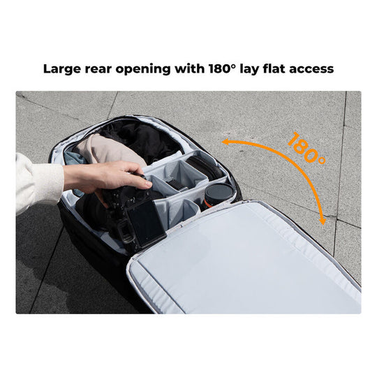 A black and gray camera bag is shown open on a paved outdoor surface, with a hand placing a camera inside. Text at the top reads &