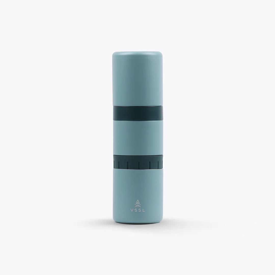 A light blue Nest Pour Over Coffee Kit with a dark teal band in the middle, featuring the VSSL logo near the bottom, set against a plain white background.