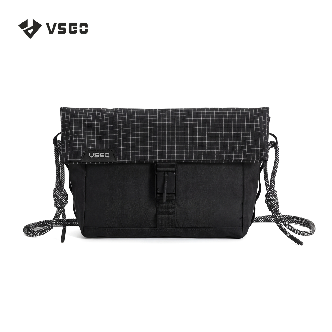 Black crossbody bag with grid pattern on top, featuring VSGO logo, on a white background