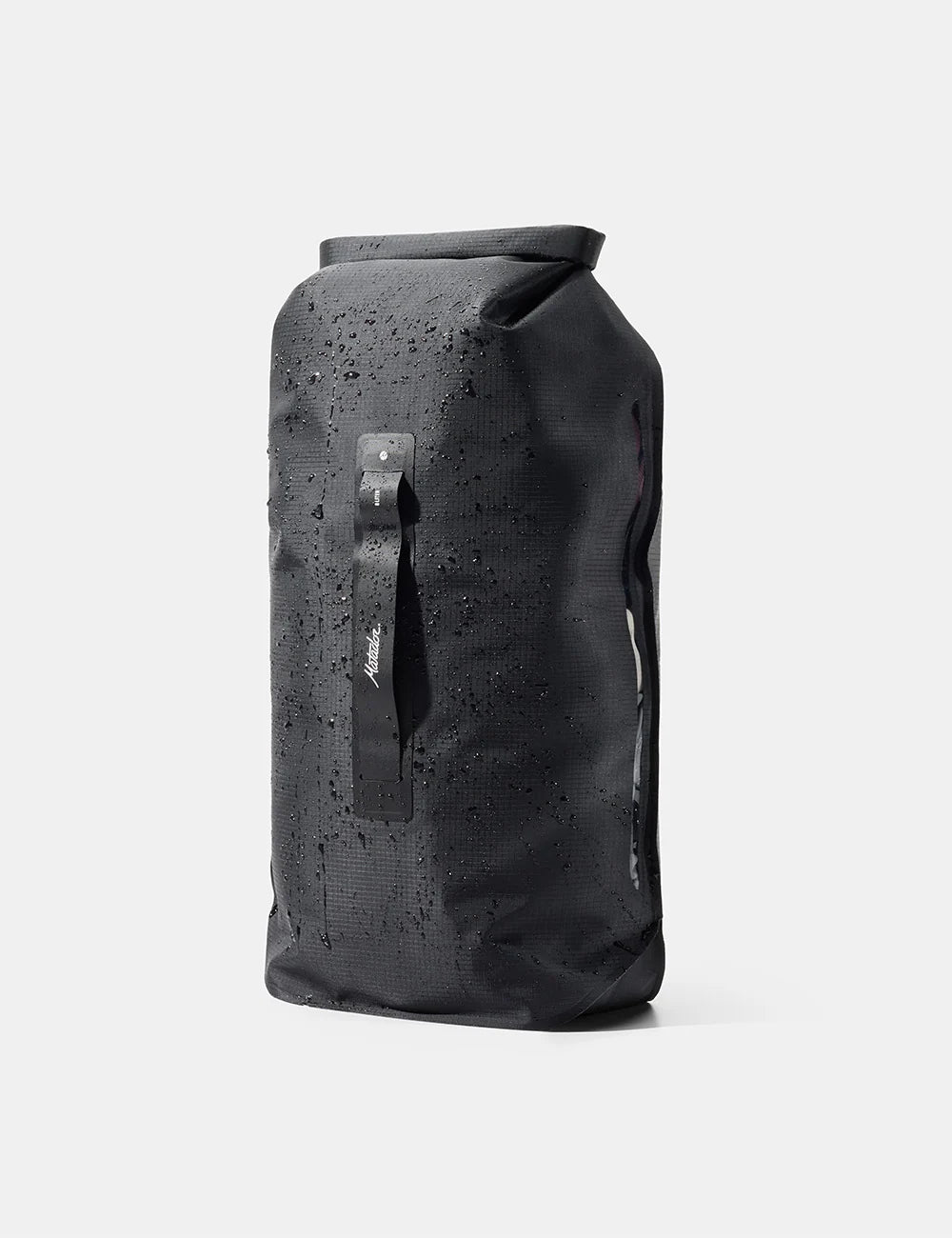 A black waterproof dry bag with a roll-top closure, covered in water droplets, featuring a vertical black strap with a white logo on the front, set against a light gray background.