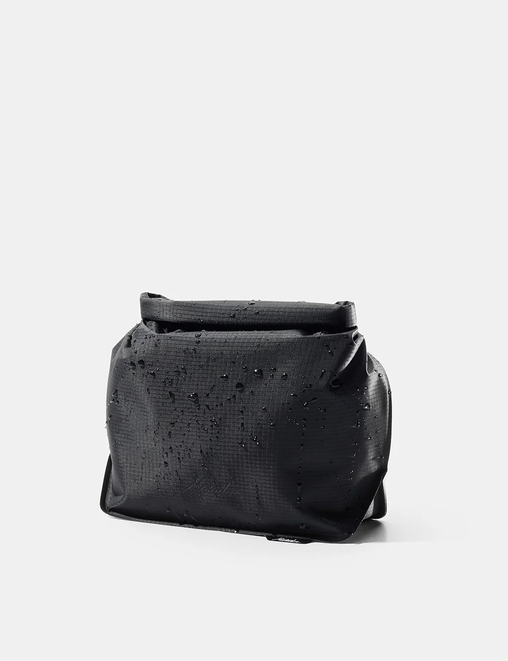 Black leather bag with studded details on a light gray background
