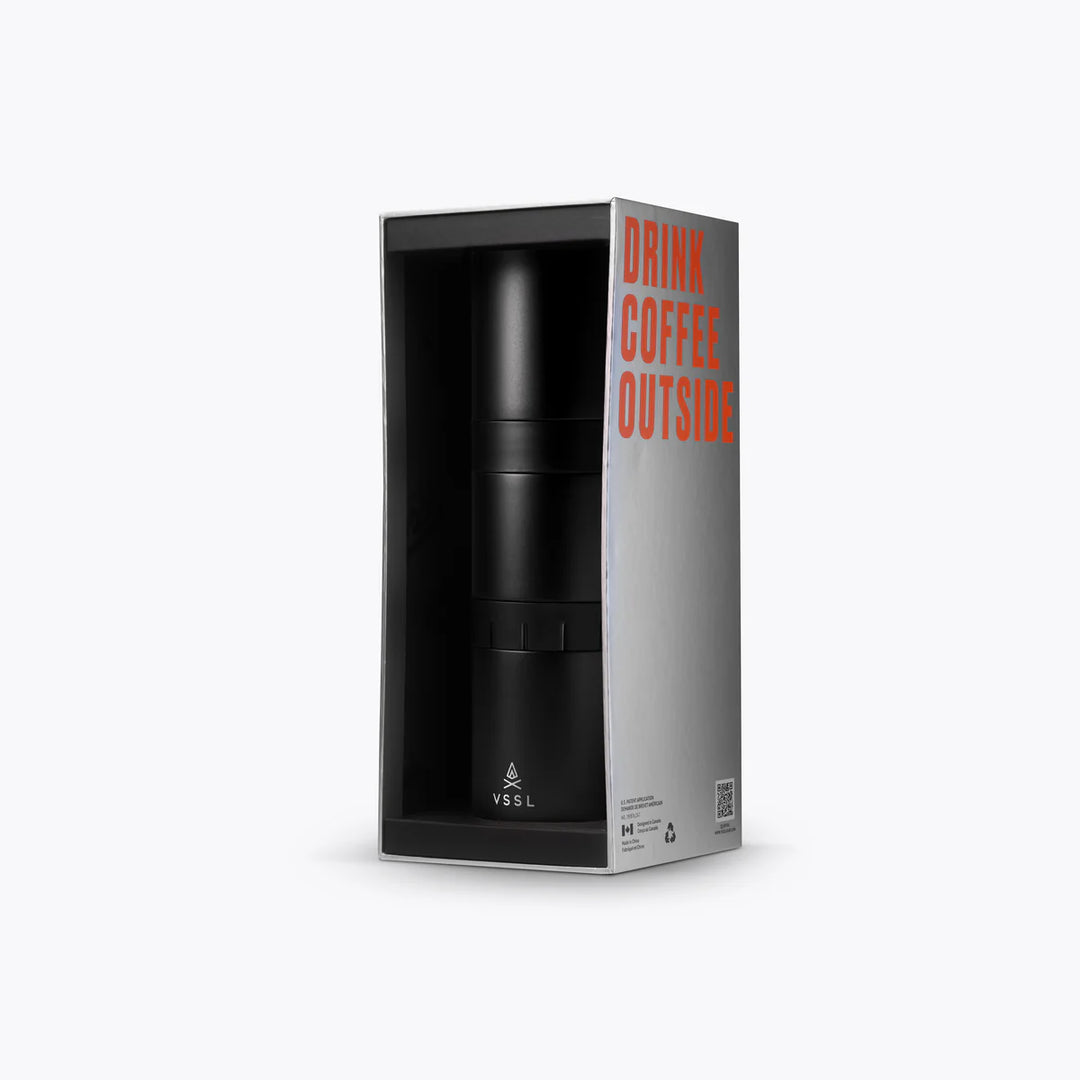 Black insulated coffee cup in packaging with &