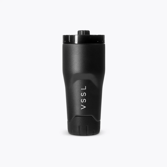 A matte black insulated travel tumbler with a matching black lid, featuring the white vertical text &