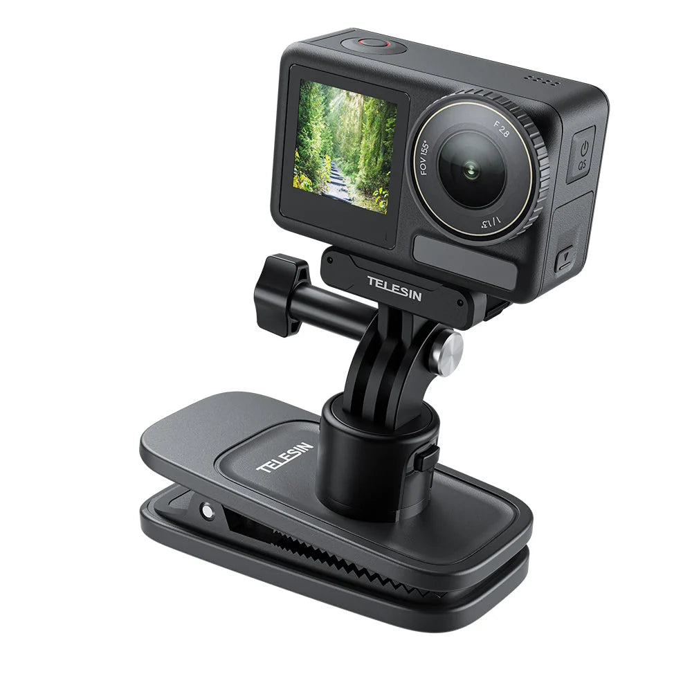 Black action camera with a rear screen showing a forest path, mounted on a black TELESIN clip-on stand against a white background.