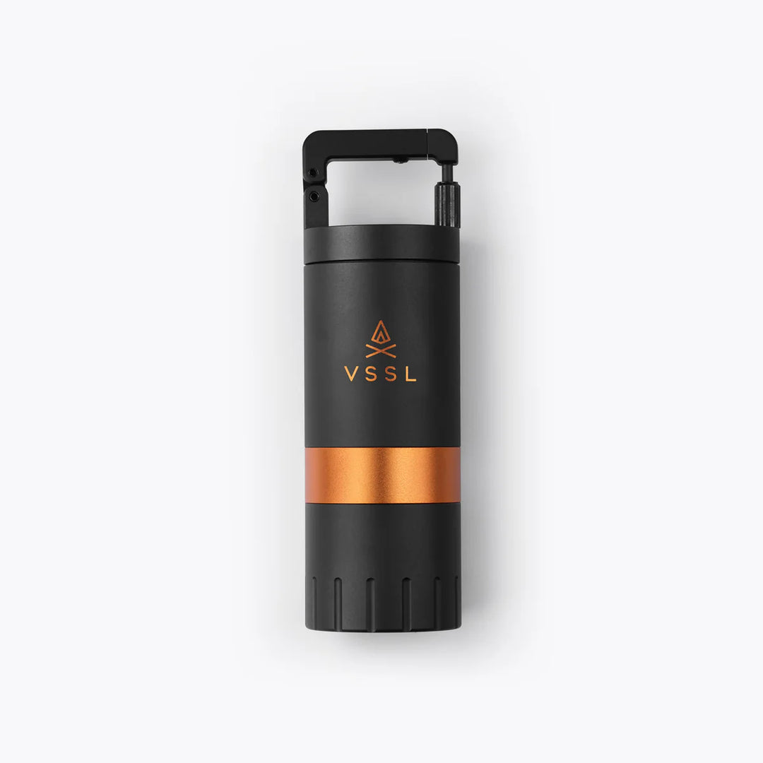 Black and copper-colored insulated bottle with VSSL logo on a white background