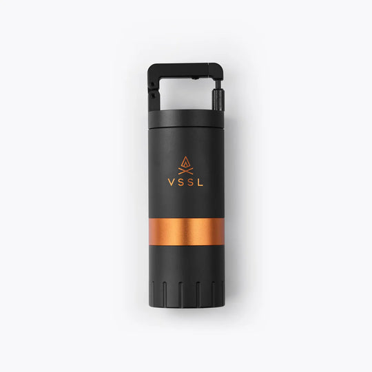 Black and copper-colored insulated bottle with VSSL logo on a white background
