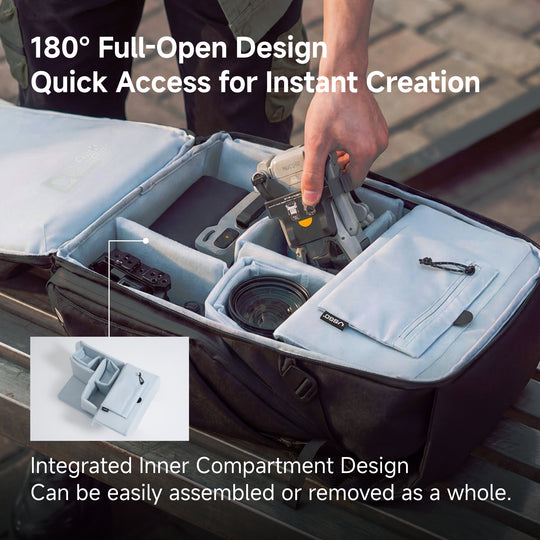 Camera bag with 180-degree open design and quick access feature, showing a hand interacting with the bag.