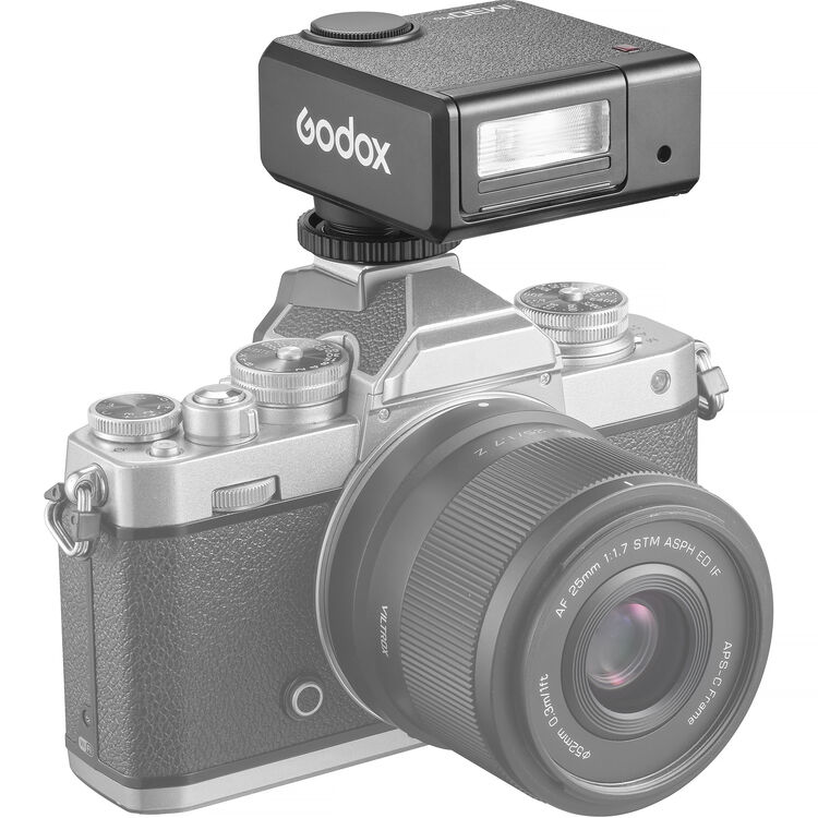 A Godox iM30Pro wireless camera flash modifier in black, featuring a textured top surface, a top dial, and a front lens window, shown on a white background with an orange Godox logo and border.