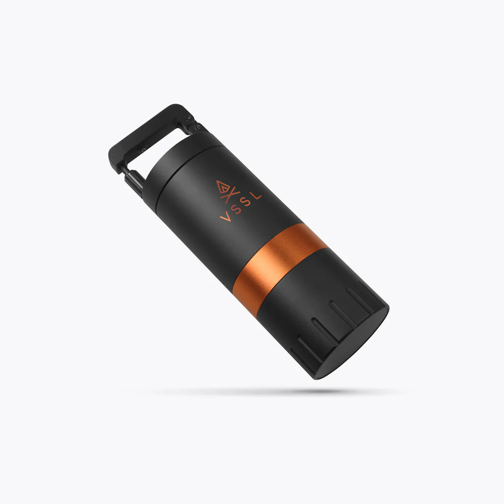 Black and copper cylindrical device on a white background