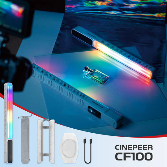 Cinepeer CF100 portable cinema light bar kit shown with the light bar illuminated, plus included accessories: a rainbow-colored light stick, a gray drawstring pouch, a white handle, a white diffuser, and a USB cable. The main light bar is shown casting a colorful glow onto a surface in a studio setup.