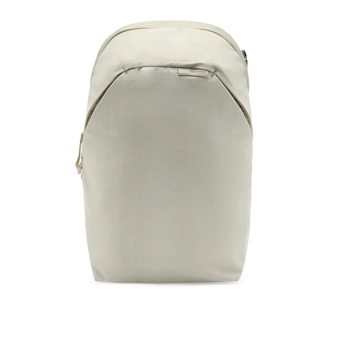 A minimalist, structured backpack in a light beige or off-white color, shown from the front against a solid white background.