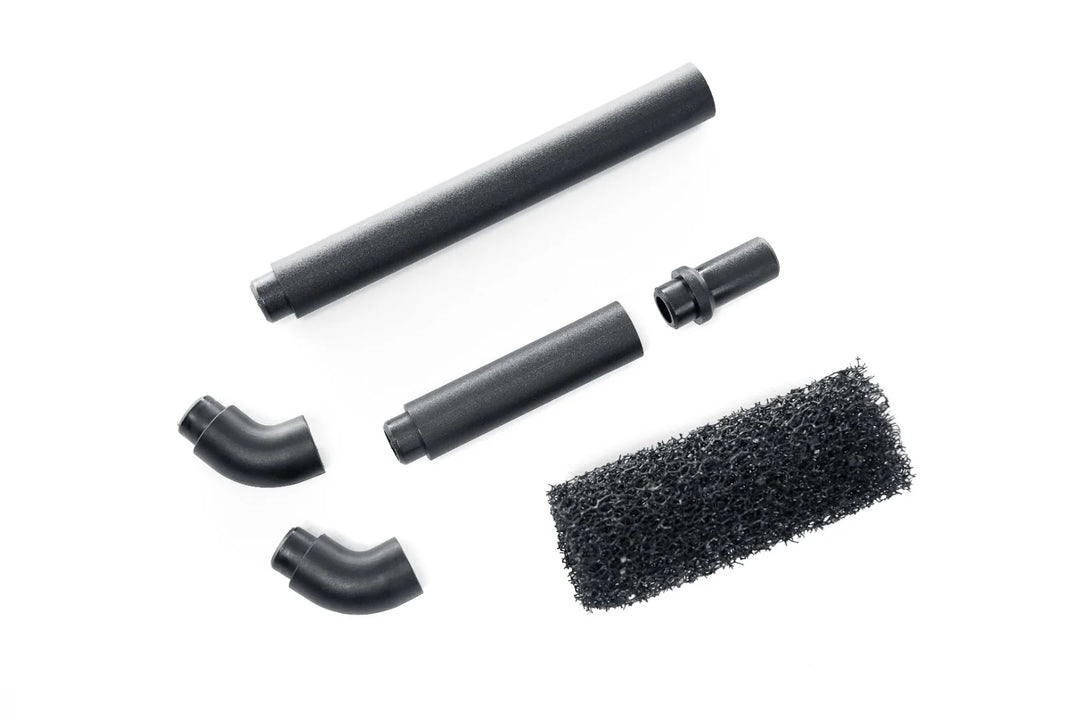 Set of black vacuum attachment parts on a white background